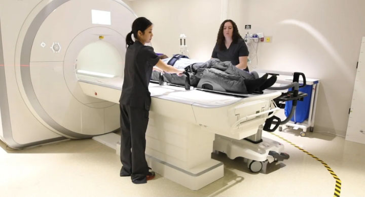 technicians scanning patient in an MRI machine