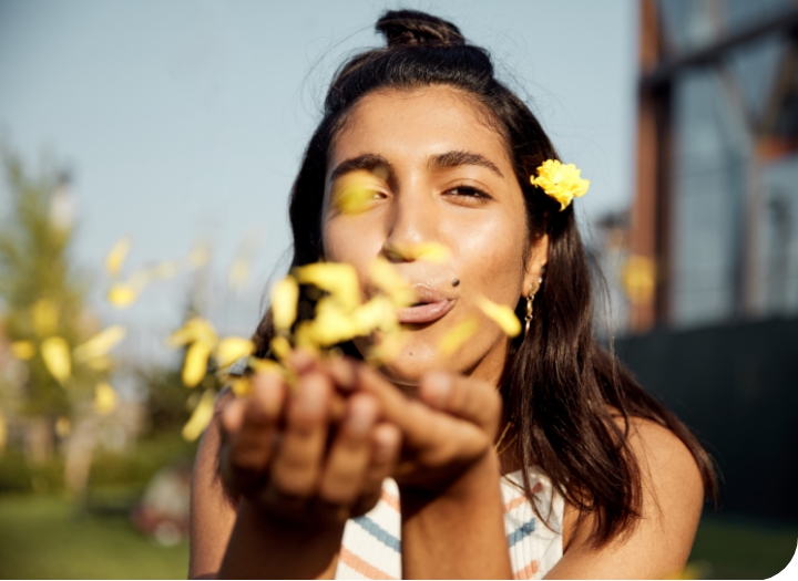 young woman scattering flower pedals