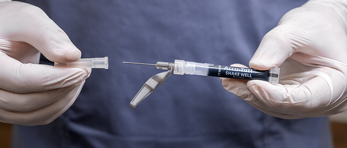 gloved hands opening Accu-Tatt  packaging